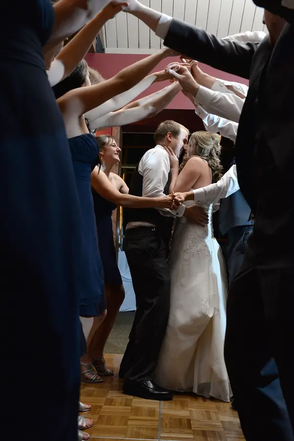 Guests dancing under colorful lights at a Madcap Milwaukee reception