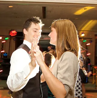 A couple sharing a first dance while the DJ keeps the celebration moving